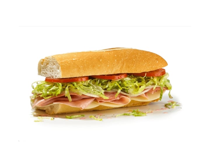 Half a sub with lettuce, tomato, Provolone, ham and salami.