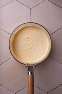 A pot filled with cheese sauce.
