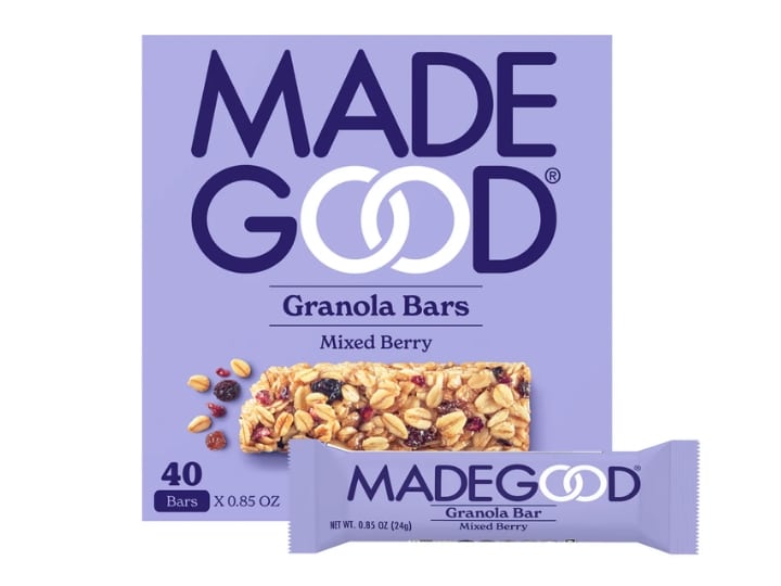 A box of Made Good mixed berry granola bars on a white background. There is an individual bar in front of the box.