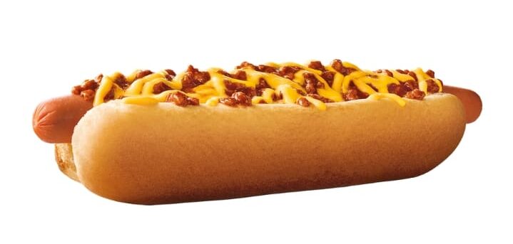 A Sonic footlong quarter pounder coney with chili and mustard drizzled on top on a white background.