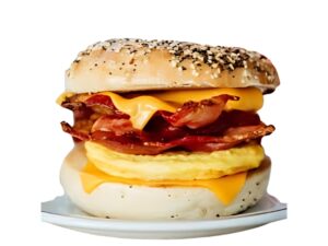 An image of a Tim Hortons bacon everything bagel breakfast sandwich on a white background.