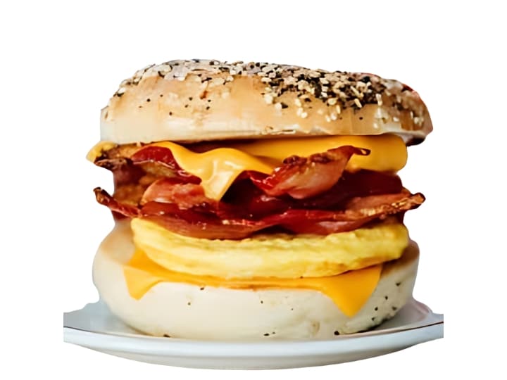 An image of a Tim Hortons bacon everything bagel breakfast sandwich on a white background.