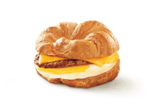 An image of a Tim Hortons sausage croissant breakfast sandwich on a white background.