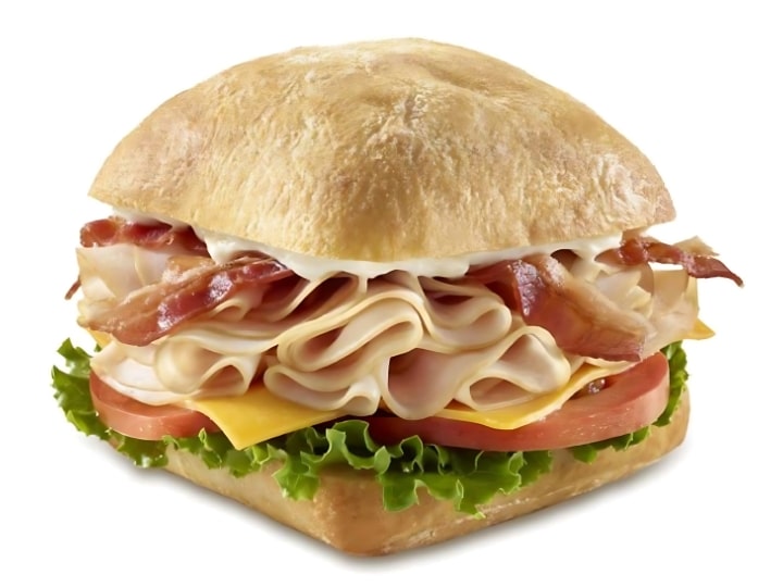 An image of a Tim Hortons turkey bacon club sandwich on a white background.