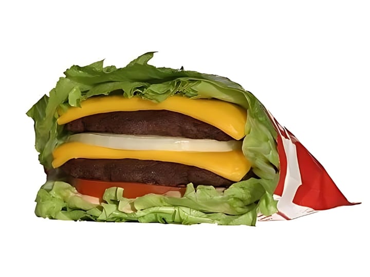 An image of an In N Out protein style cheeseburger with onion on a white background.