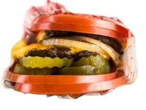 An image of an In N Out tomato wrapped cheeseburger on a white background.
