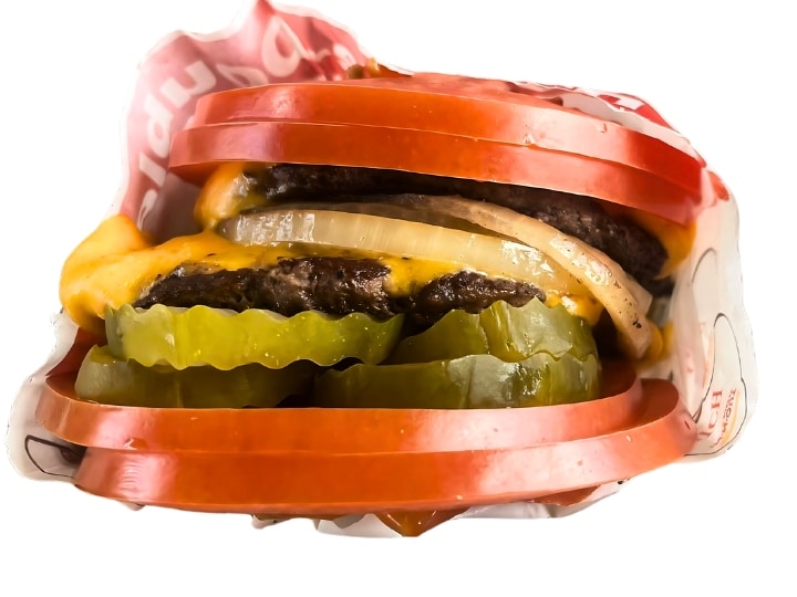 An image of an In N Out tomato wrapped cheeseburger on a white background.