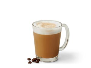 An image of espresso from Krispy Kreme in a glass mug with several espresso beans next to it An image of a vanilla iced coffee from Krispy Kreme on a white background.