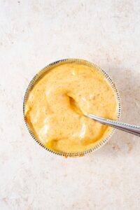 Burger sauce in a small bowl with a spoon.