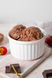 Two scoops of chocolate cottage cheese ice cream in a ramekin.