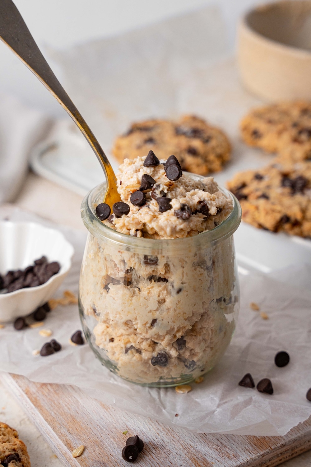 A small cup of cottage cheese cookie dough with a spoon sticking out.