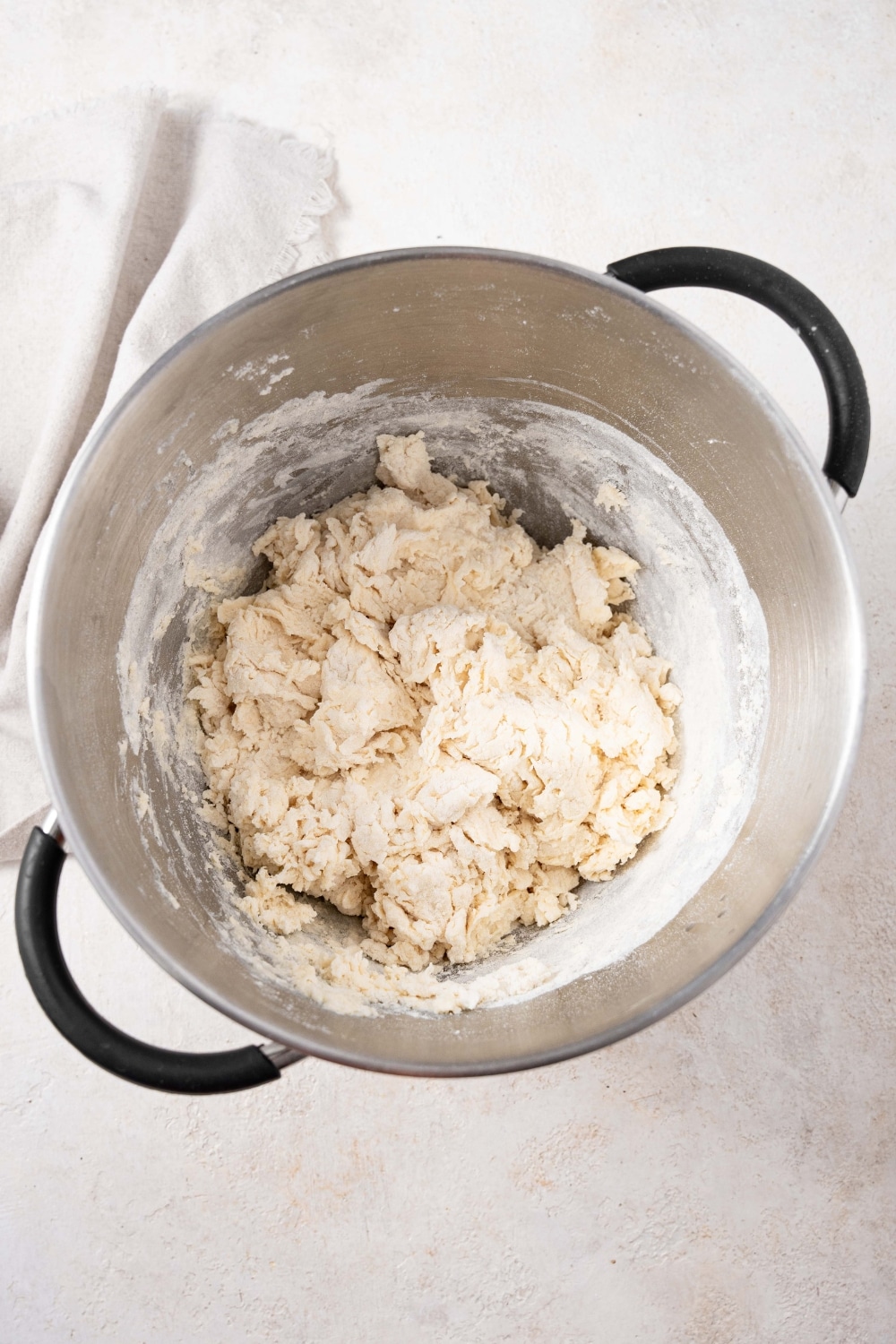 Partially mixed bread dough in a large pot.