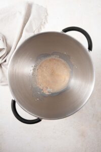 Yeast mixed with honey and milk in a large pot.