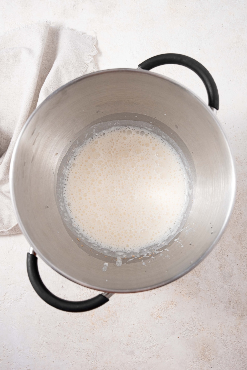 Wet ingredients mixed with active yeast in a large pot.