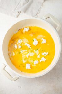 Eggs topped with cottage cheese in a pot.