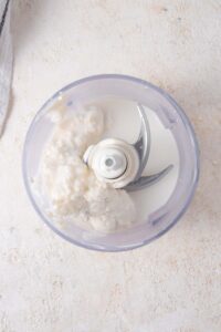 Cottage cheese and 2% milk in a food processor.