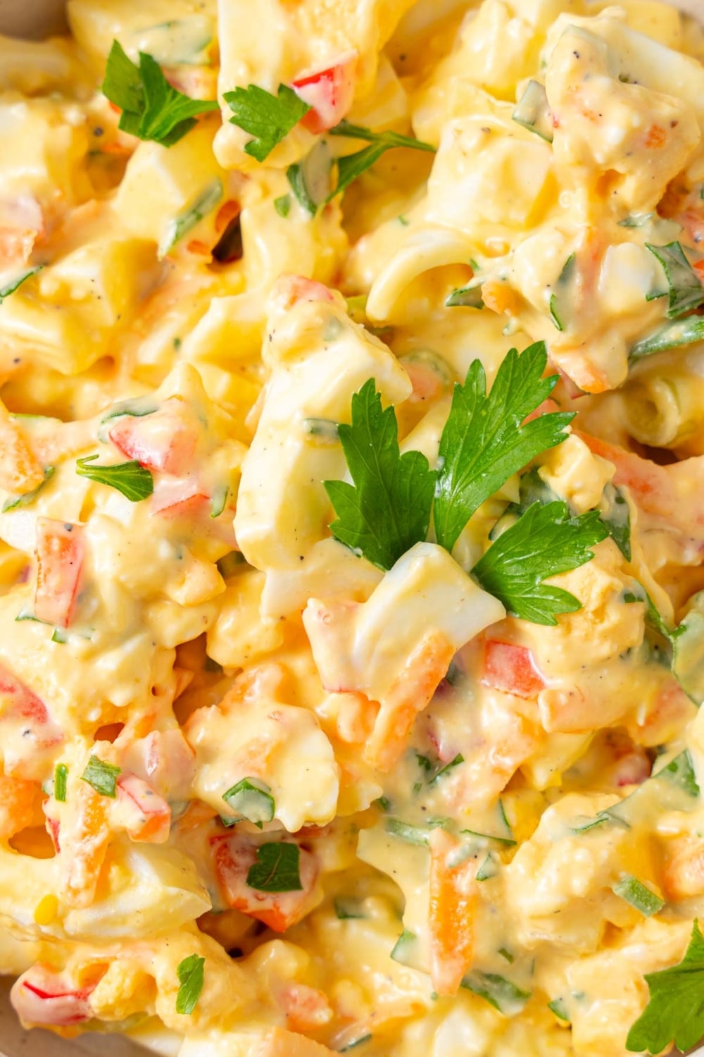 A close up of cottage cheese egg salad garnished with fresh parsley.