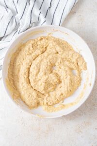 Cottage cheese banana pancake batter in a white bowl.