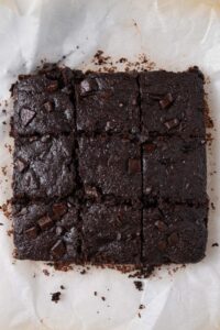 Freshly cut cottage cheese brownies on a parchment paper.