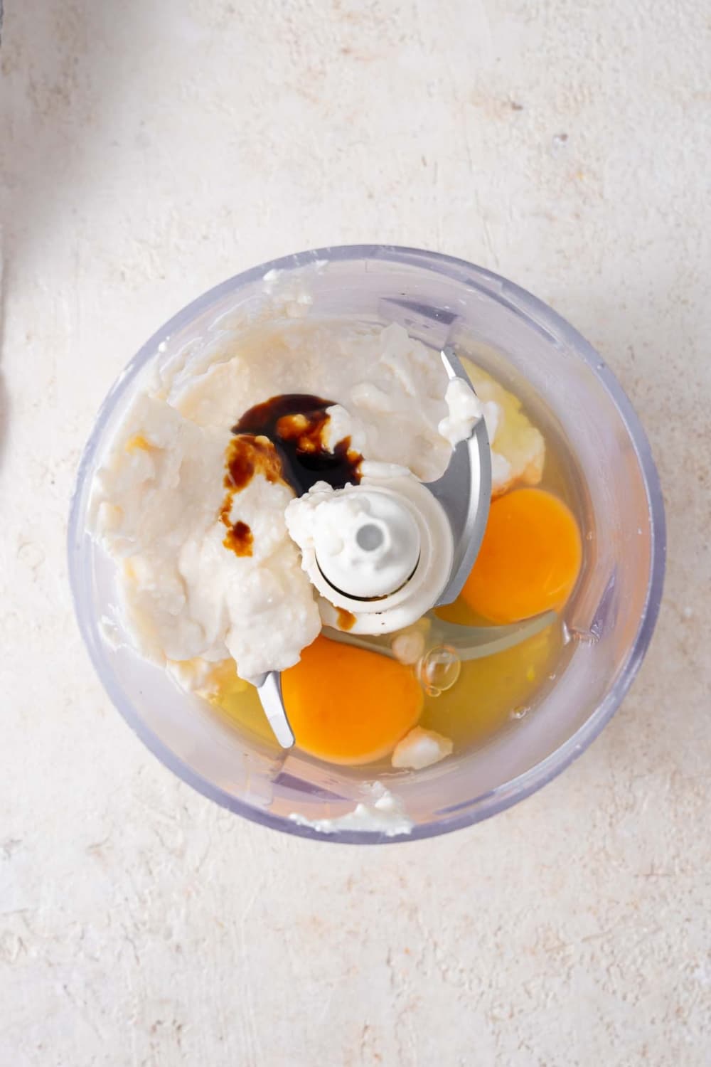 Cottage cheese, eggs, and vanilla extract in a food processor.