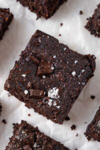 A closer look at a cottage cheese brownie filled with melty chocolate chunks and finished with flaky sea salt.