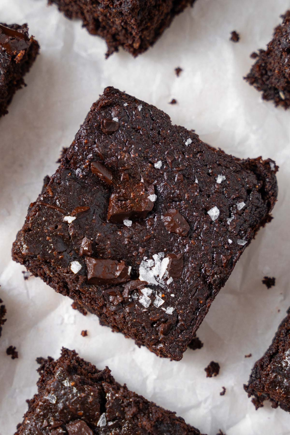 A closer look at a cottage cheese brownie filled with melty chocolate chunks and finished with flaky sea salt.