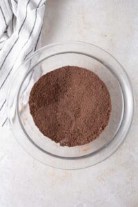 Dry ingredients for the cottage cheese brownie batter mixed in a glass bowl.