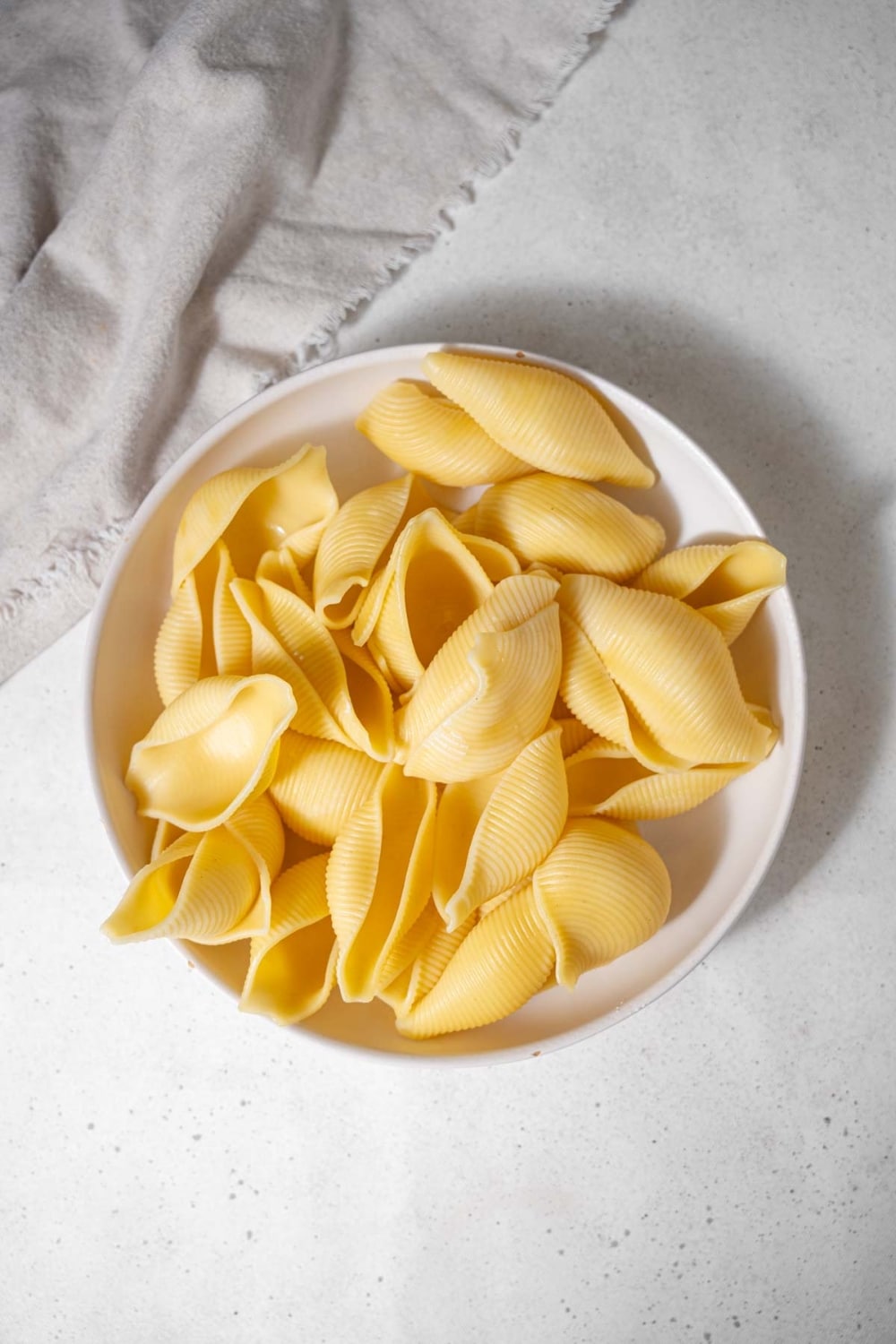 Cooked pasta shells in a bowl.