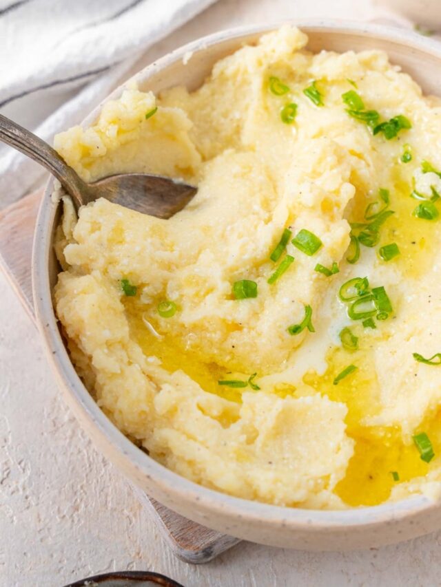 Scooping cottage cheese mashed potatoes with a spoon.