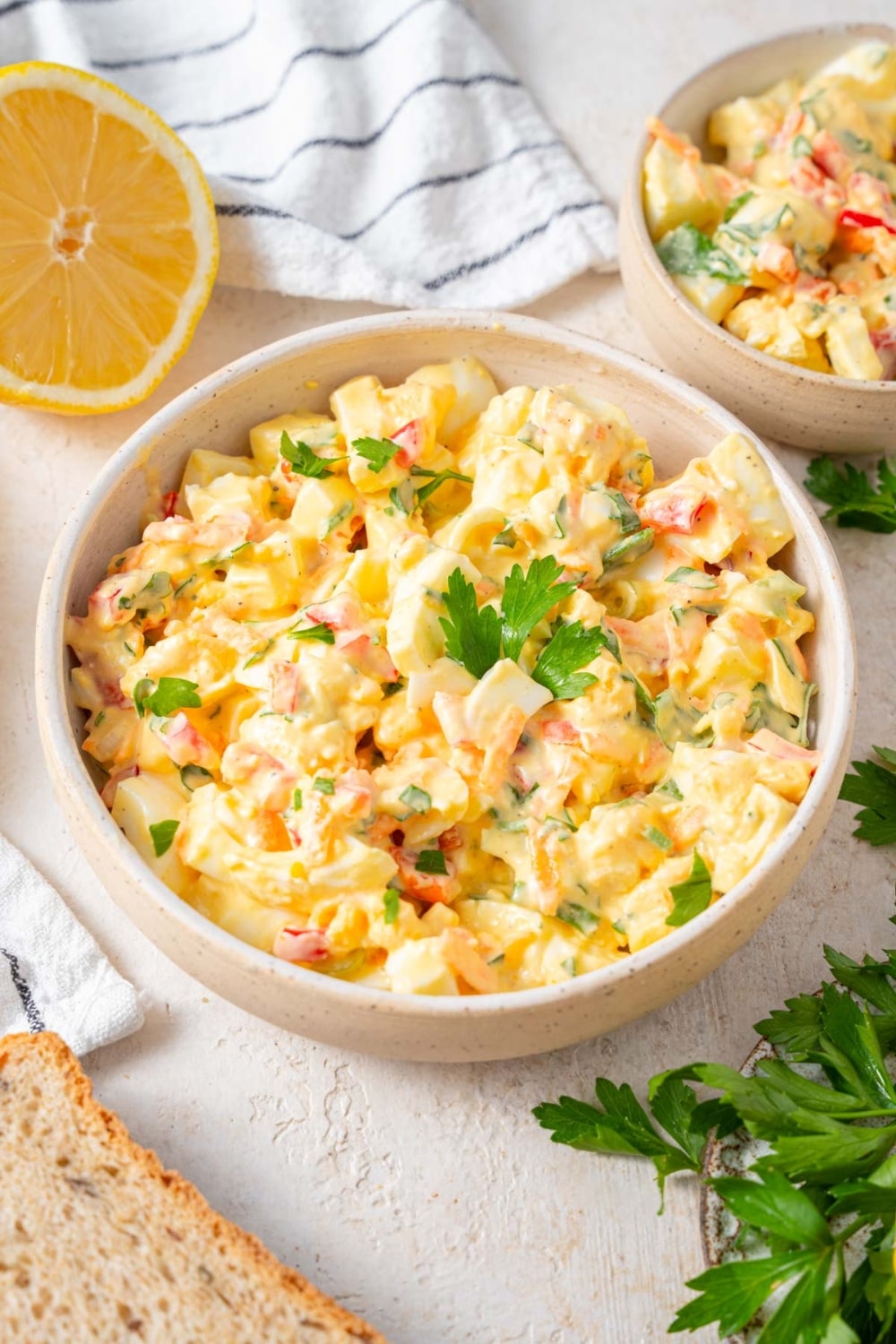 A bowl of cottage cheese egg salad finished with fresh parsley.