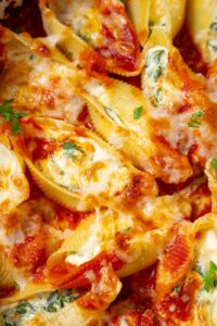 A closer look at spinach and cottage cheese stuffed shells in cheesy marinara sauce.