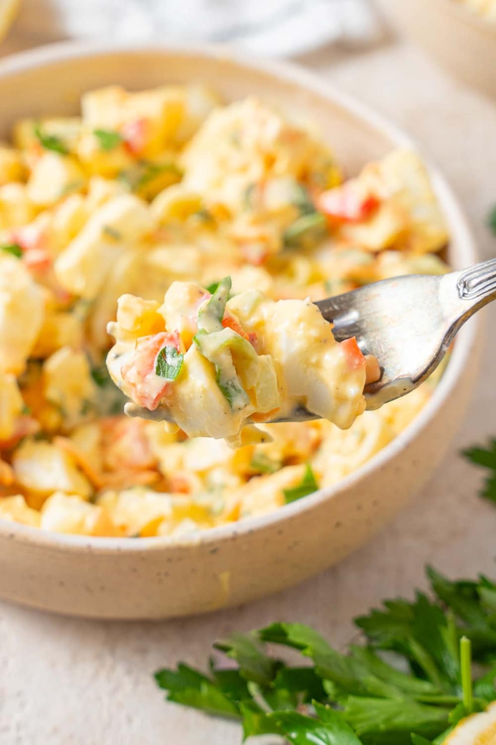 A scoop of cottage cheese egg salad on a fork.