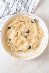 Cottage cheese banana pancake batter with fresh blueberries mixed in.