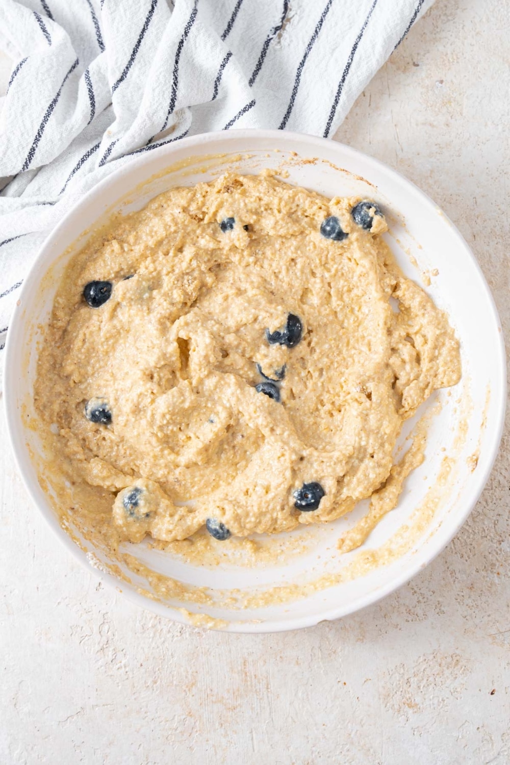 Cottage cheese banana pancake batter with fresh blueberries mixed in.