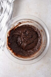 Cottage cheese brownie batter in a glass bowl.