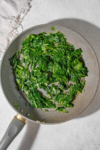 Sauteed spinach in a skillet.