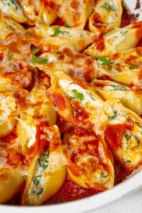 A closer look at spinach cottage cheese stuffed shells in cheesy marinara sauce.