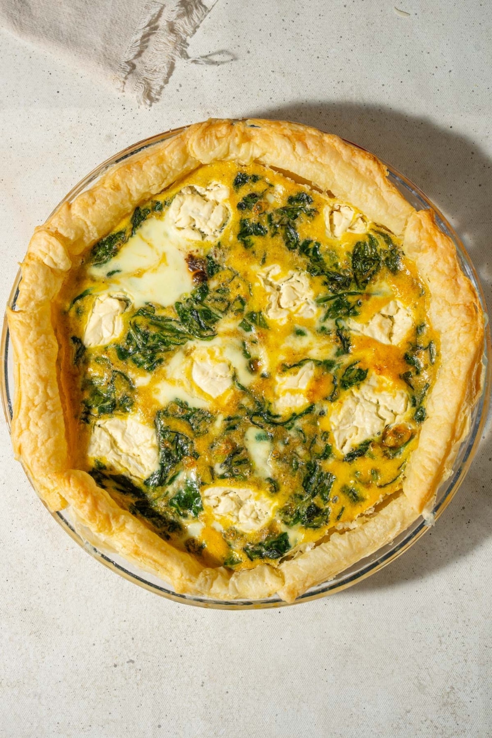 A spinach quiche with whipped cottage cheese topping.