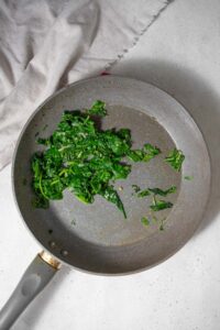 Sauteed spinach in a skillet.
