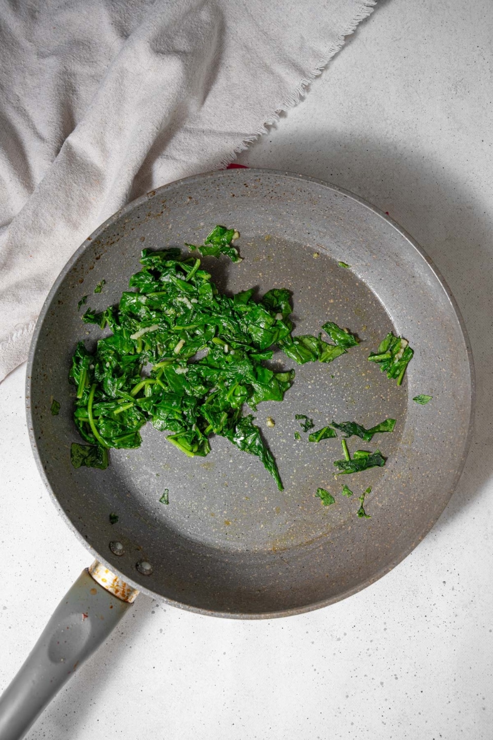 Sauteed spinach in a skillet.